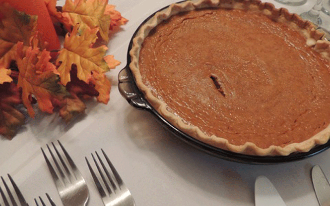 Thanksgiving table with Pumpkin pie and forks