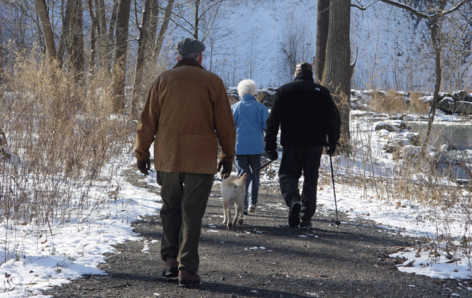 one female and two males hiking in the winter